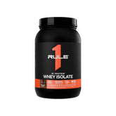 Black container of Rule 1 Whey Isolate protein powder on a white background in Pakistan