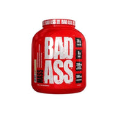 A red plastic container of Bad Ass Mass Gainer 3kg with white text detailing the product name, weight, and benefits.