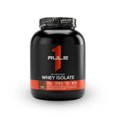 A black plastic container of Rule 1 R1 Whey Protein Isolate with a label that features the brand logo and product name, against a white background.