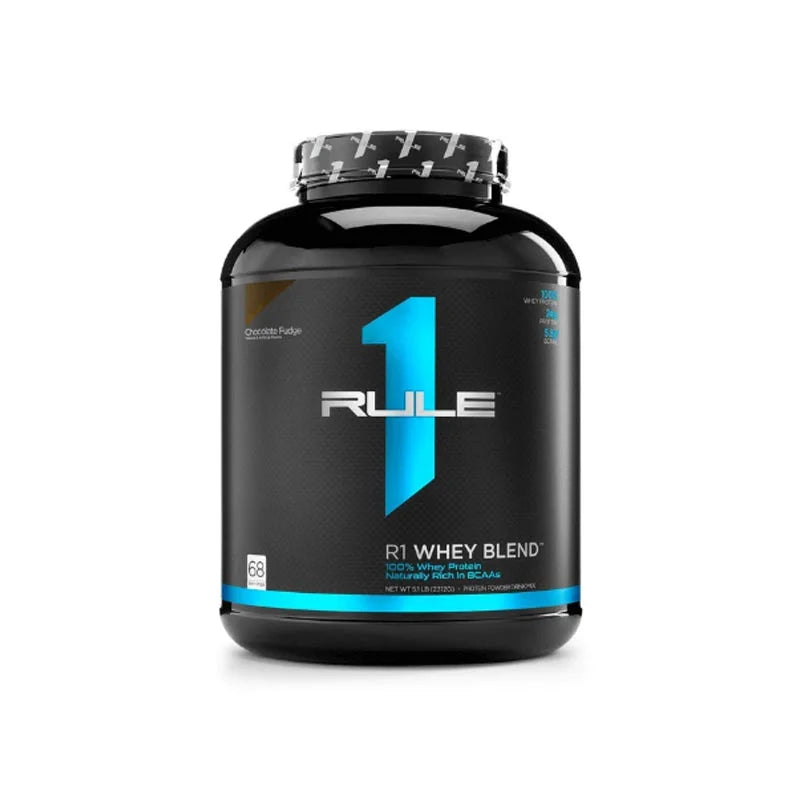 A container of Rule 1 R1 Whey Blend Protein powder, with a black and blue label, indicating 5lbs (2.27kg) of the product.